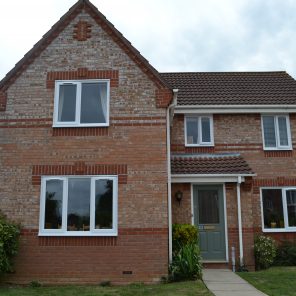White uPVC windows and Chartwell green door