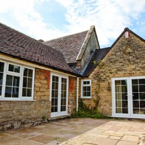 White UPVC French doors and replacement windows with Georgian bars