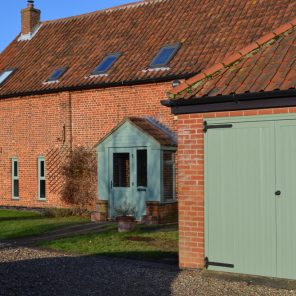 Chartwell green garage door and matching double glazed windows and doors