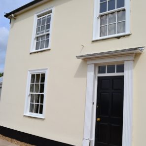 White vertical slider sash windows with Georgian bars