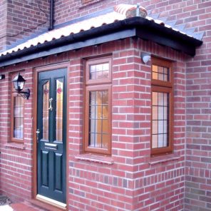 Full brick porch with double glazed windows in woodgrain finish